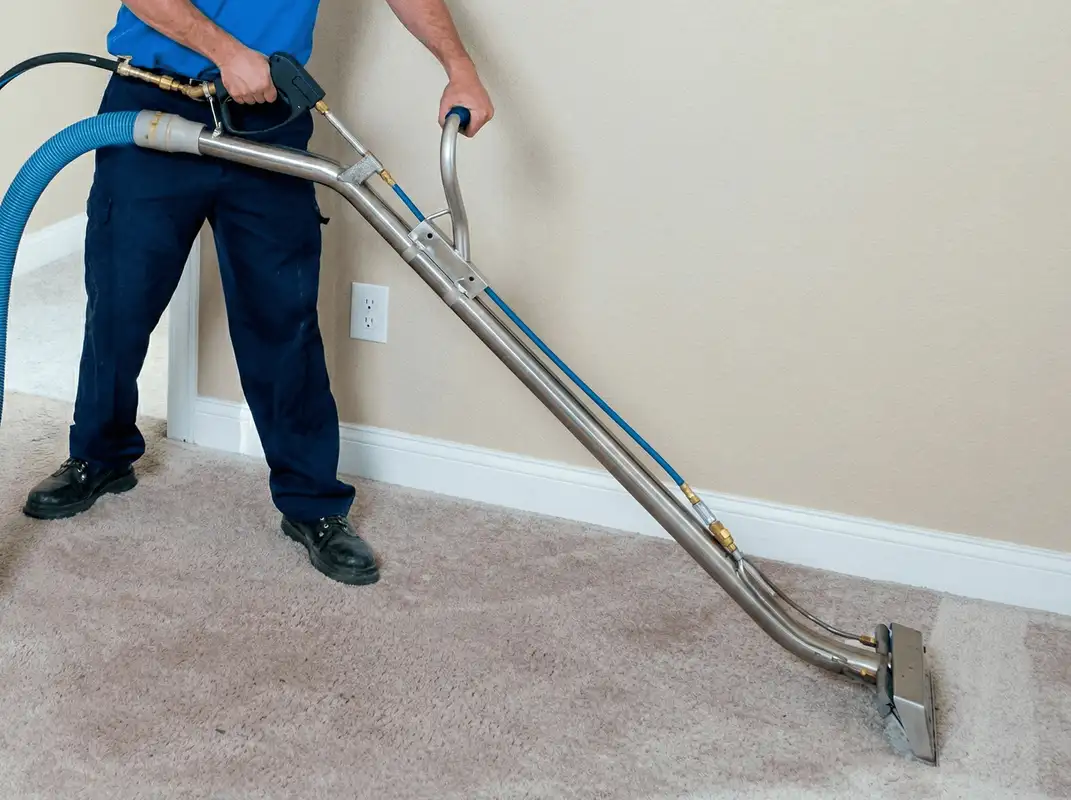 Professional operating a liquid removal machine on a carpeted floor in Columbia, MO
